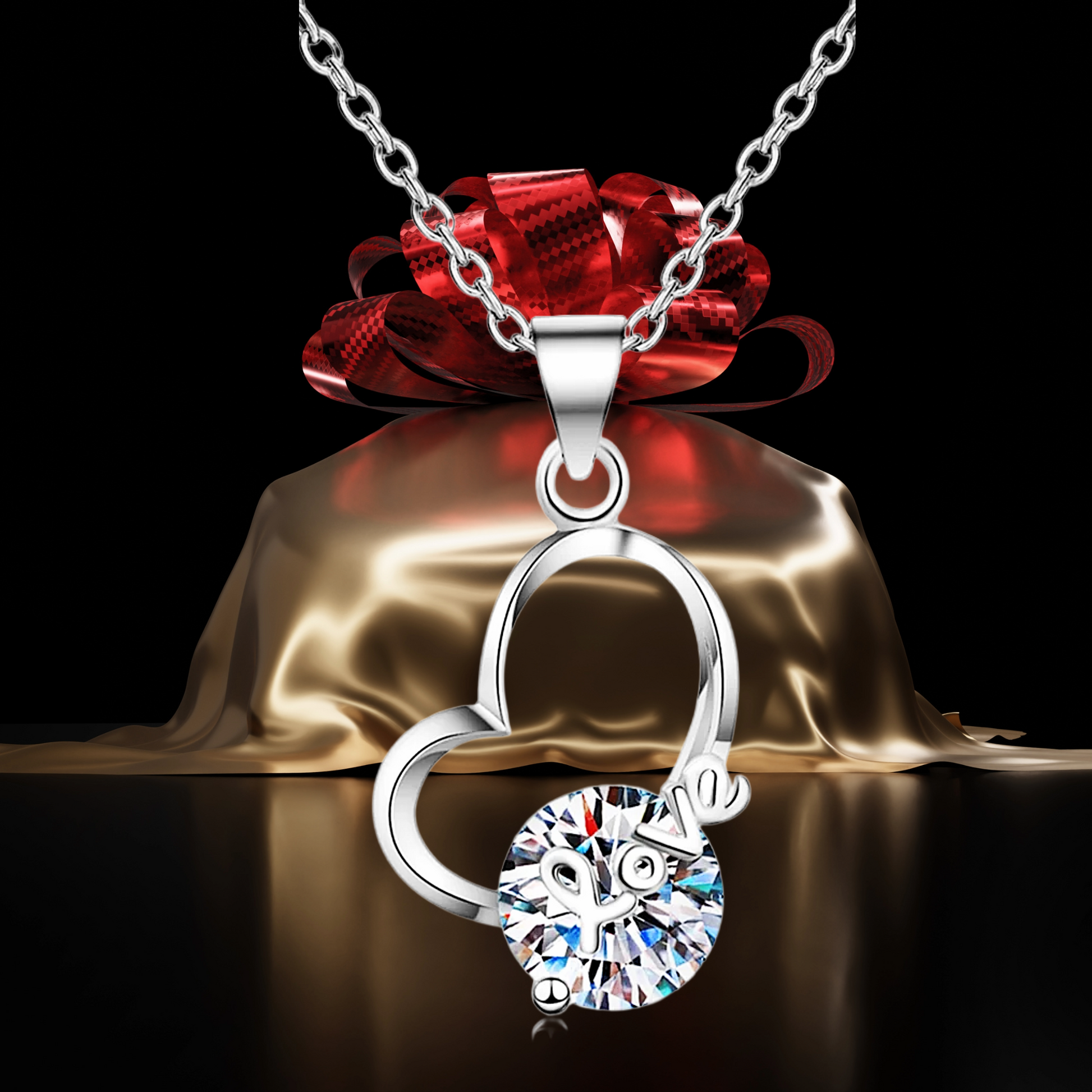 Silver necklace with a round pendant on a gold base and red bow against a black background