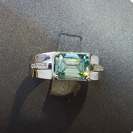 Ring with a green gemstone on a dark surface