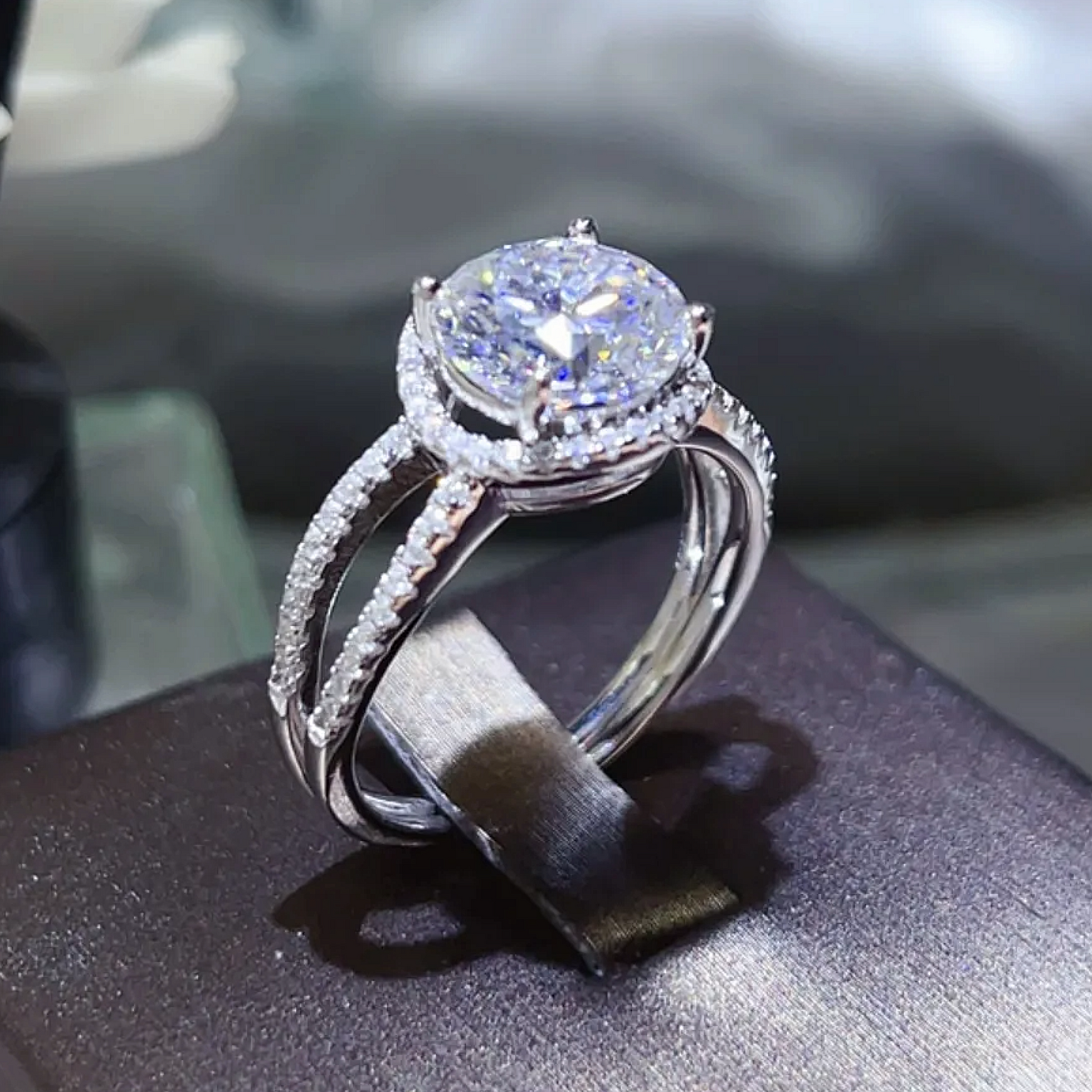 Silver ring with a large diamond on a dark surface