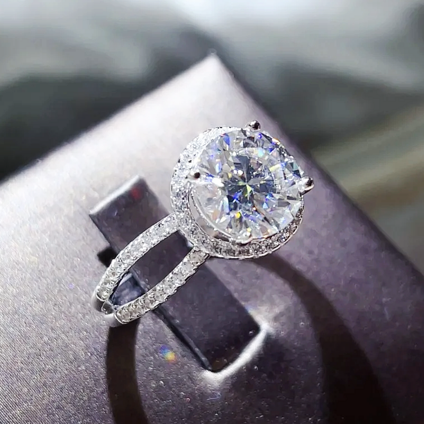 Diamond ring on a dark surface with a blurred background