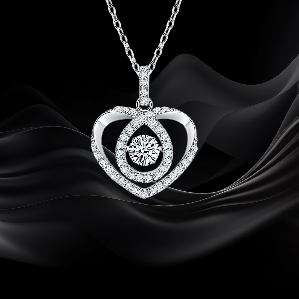 Heart-shaped diamond pendant on a black fabric background