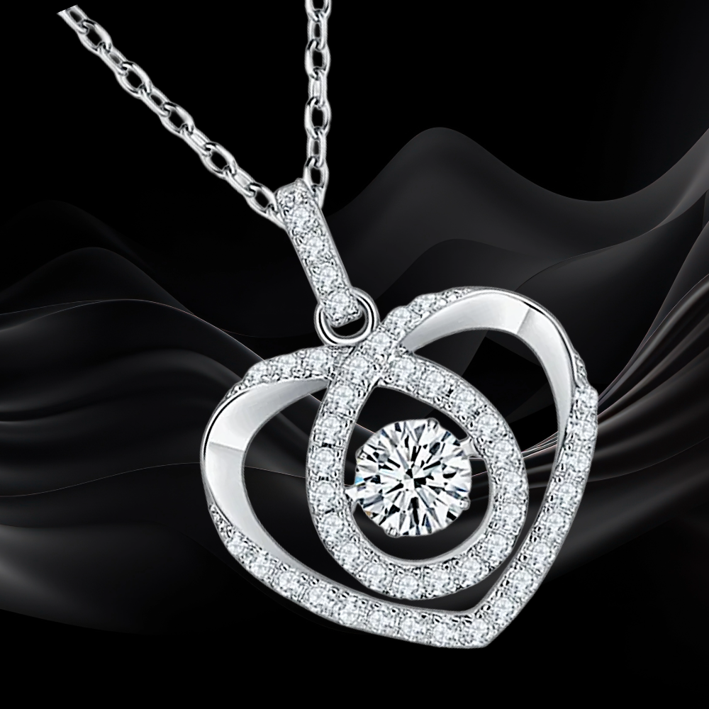 Silver necklace with a heart-shaped pendant on a black fabric background