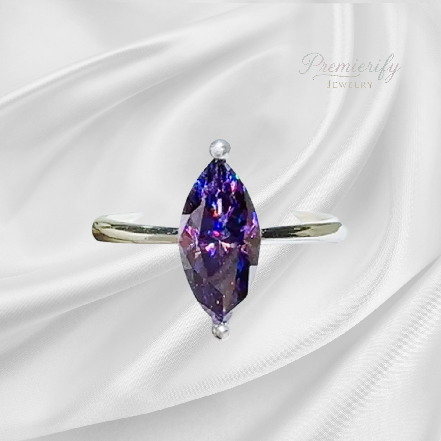 Ring with a purple gemstone on a white satin background, featuring the brand 'Premierify Jewelry'.