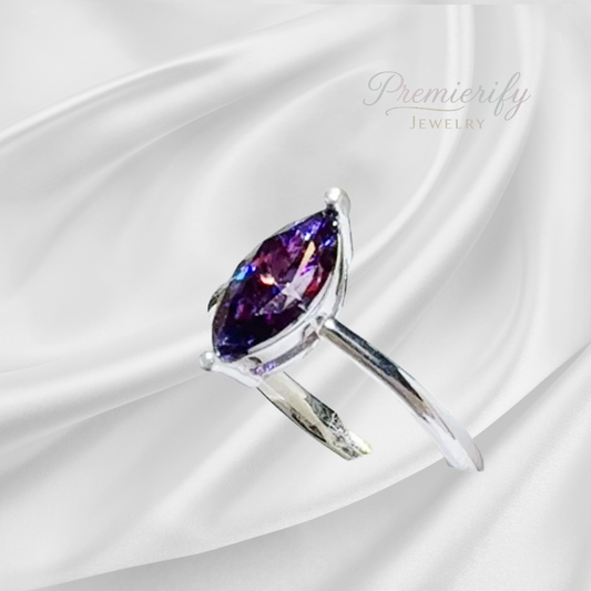 Silver ring with a purple gemstone on a white satin background, featuring the brand 'Premierify Jewelry'.