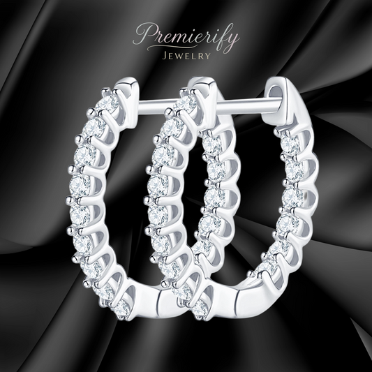 Silver hoop earrings with clear stones on a black satin background, branded 'Premierify Jewelry'.