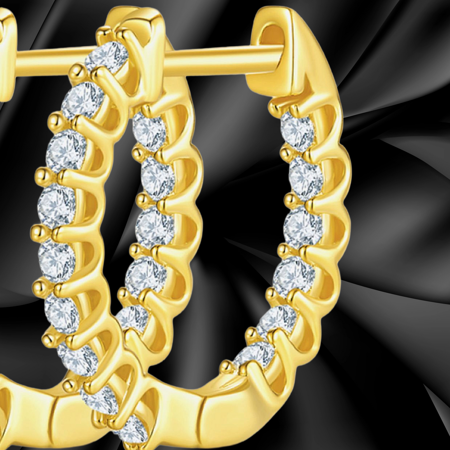 Gold hoop earrings with clear gemstones on a black background