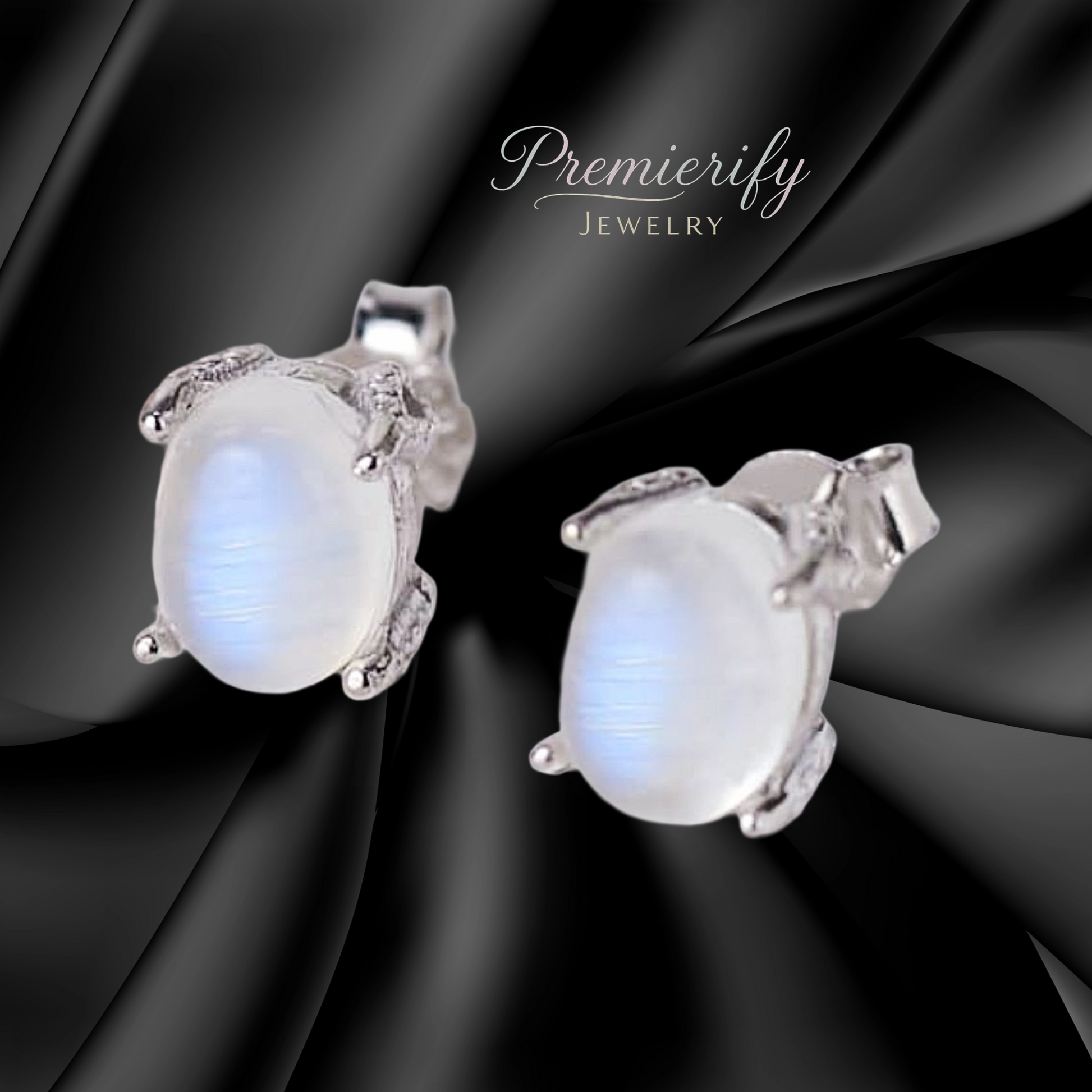 Pair of silver earrings with moonstone stones on a black satin background, branded 'Premierify Jewelry'.