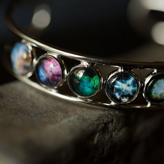 Close-up of a bracelet with colorful gemstones on a dark background
