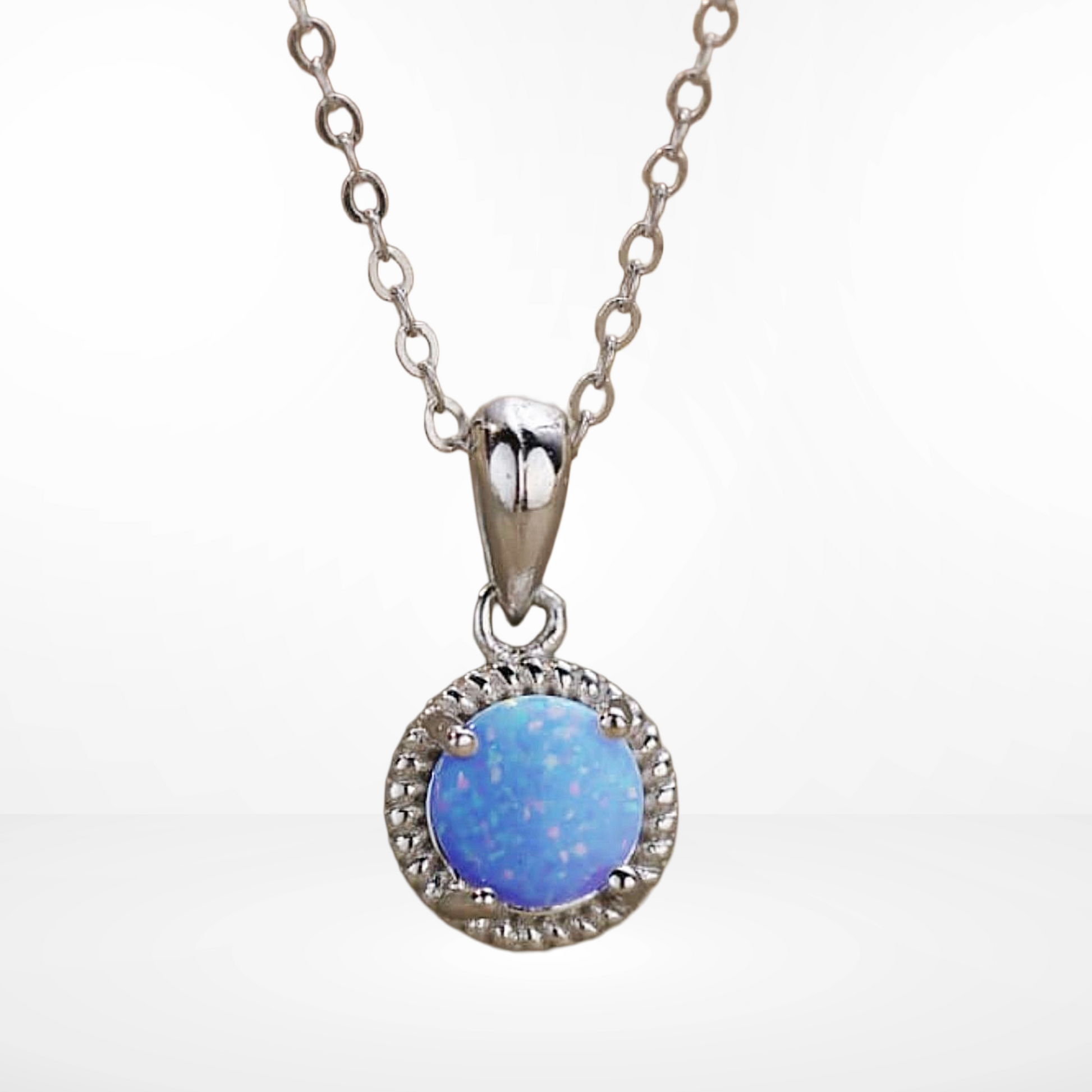 Silver necklace with a blue opal pendant on a white background