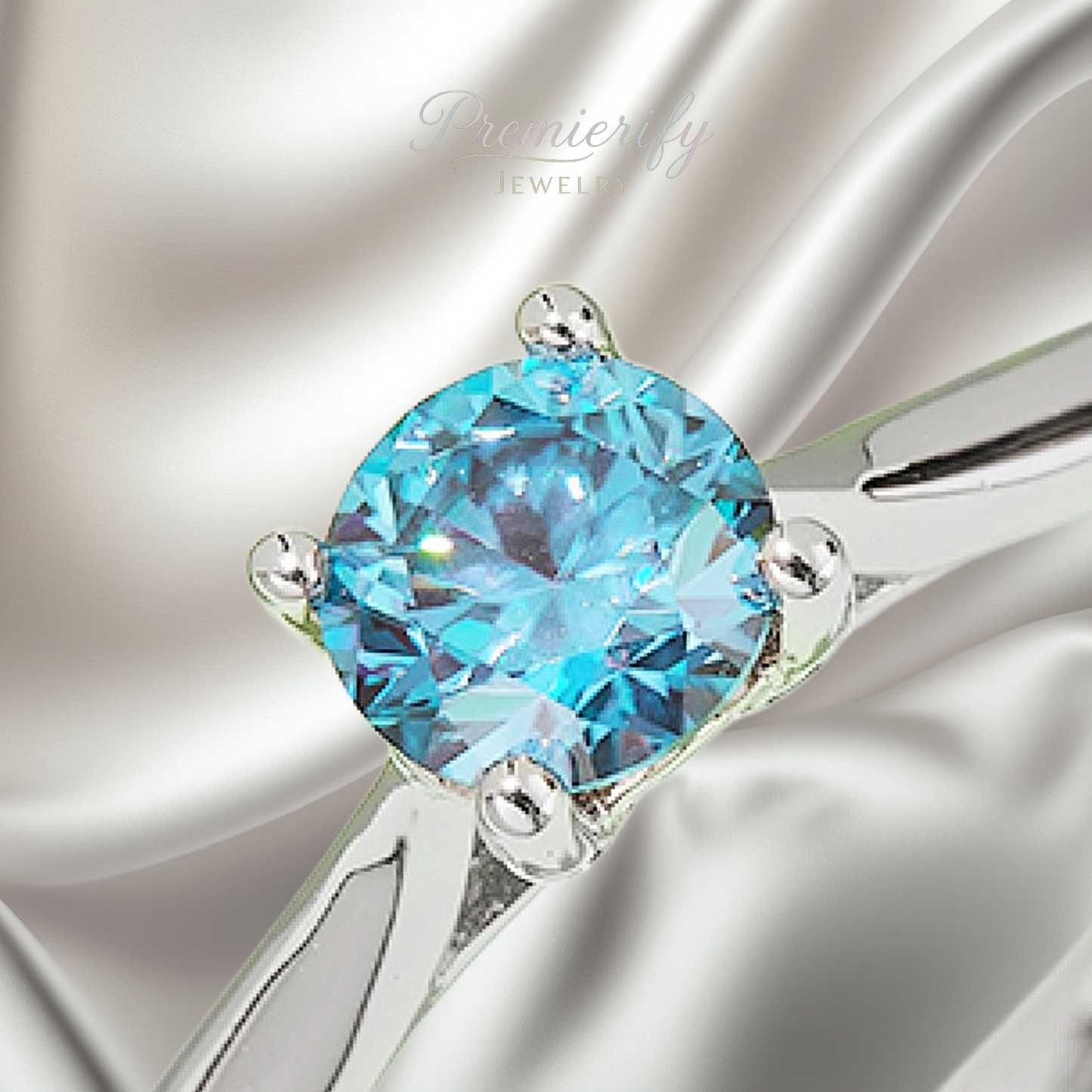 Silver earring with a blue gemstone on a white background