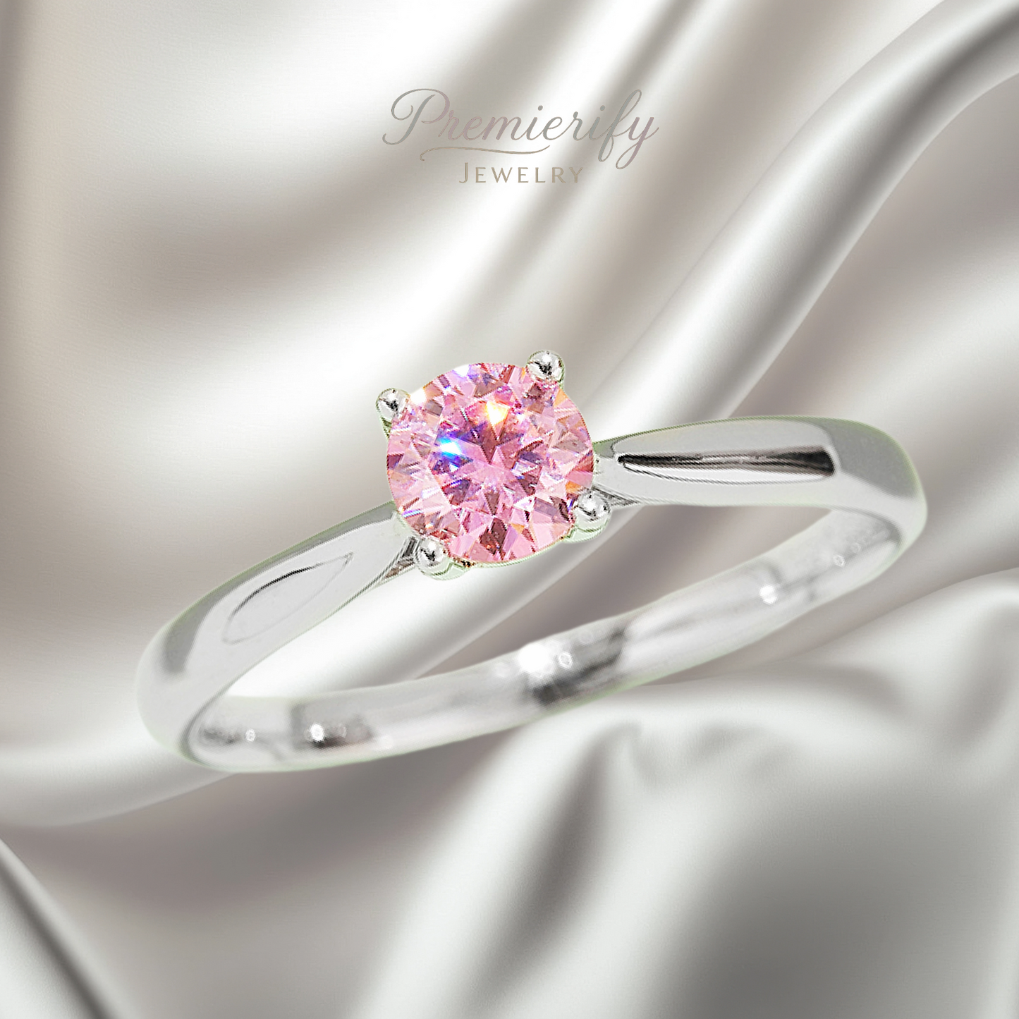 Silver ring with a pink gemstone on a satin background, featuring the brand 'Premierify Jewelry'.