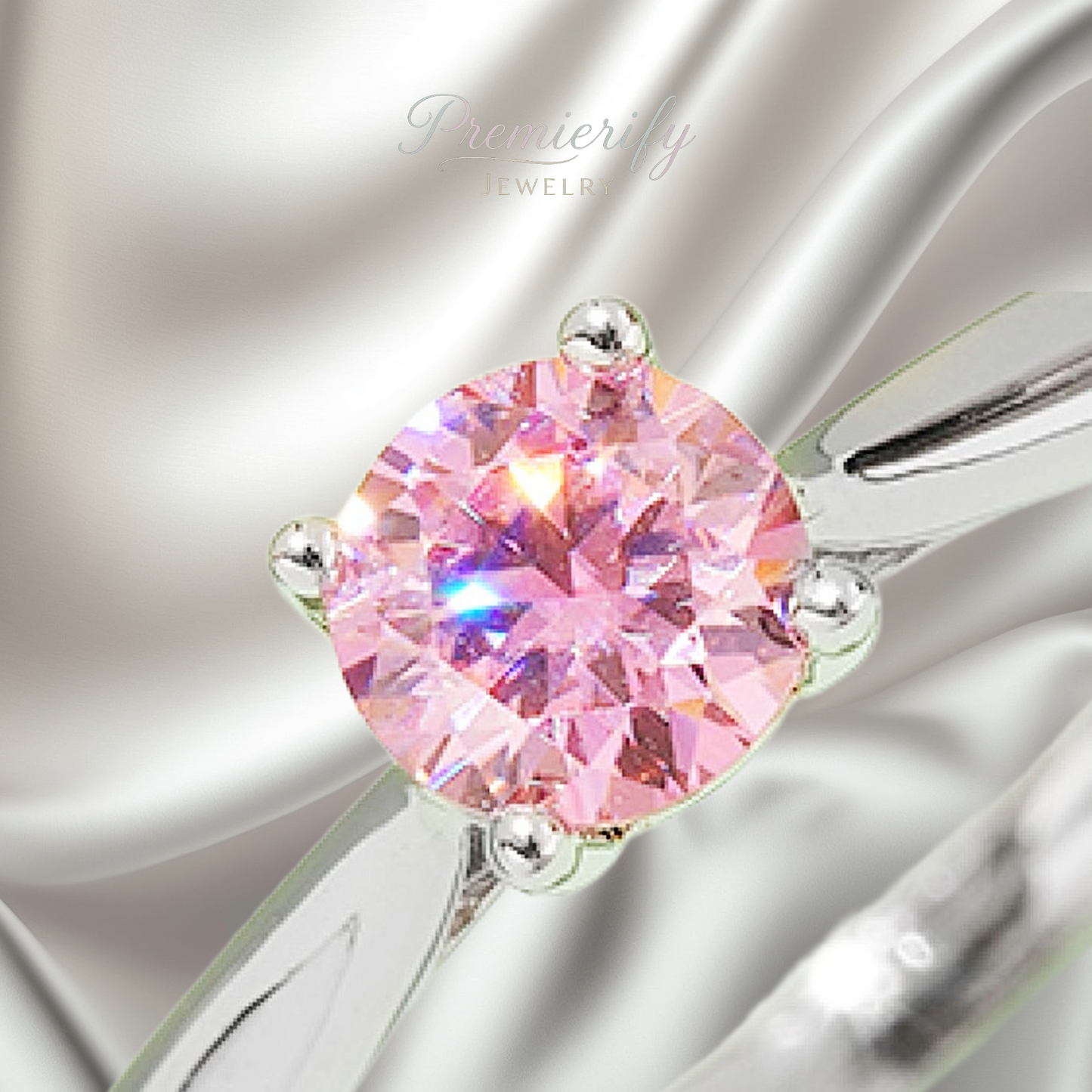 Pink gemstone ring with silver setting on a soft gray background