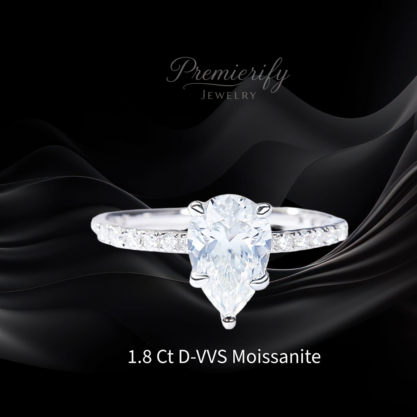 Diamond ring with pear-shaped gemstone on black fabric, featuring 'Premierify Jewelry'.