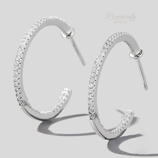 Silver hoop earrings with clear stones on a light gray background, branded 'Premierify Jewelry'.
