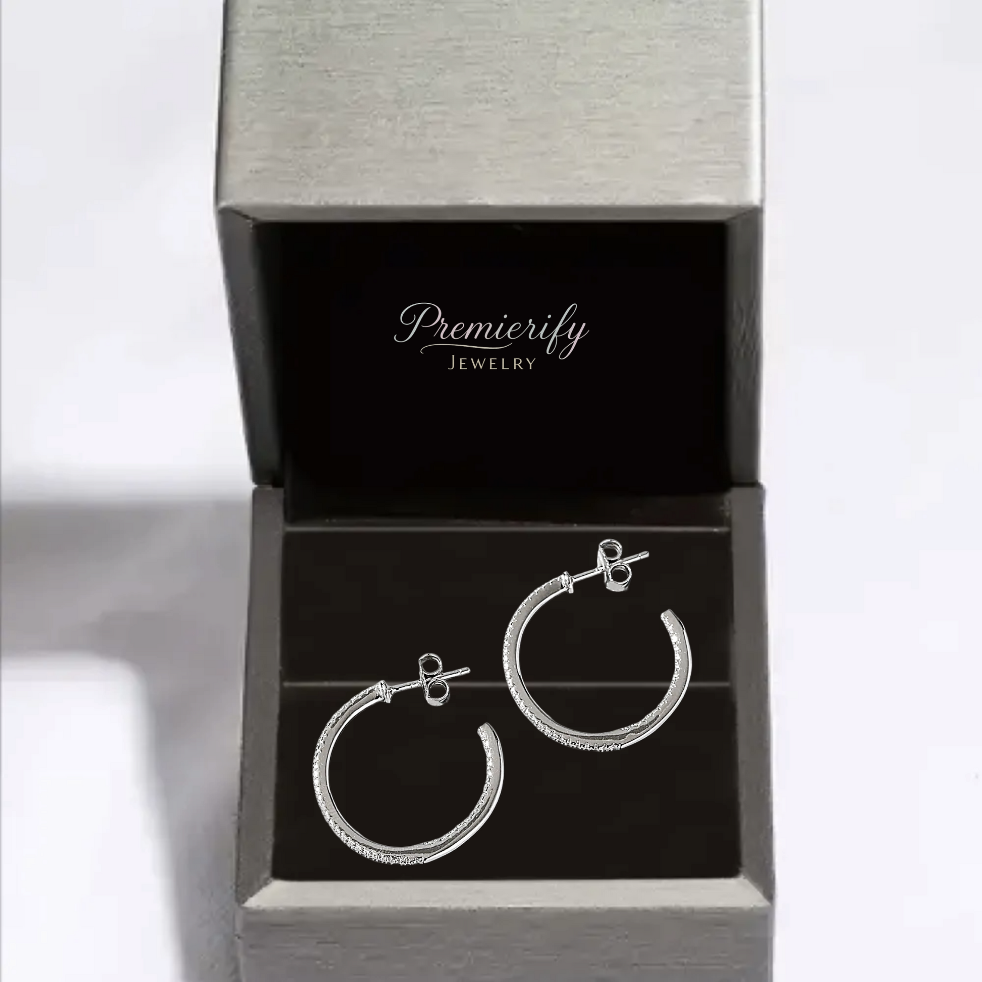 Silver hoop earrings in an open Premierify Jewelry box on a white background